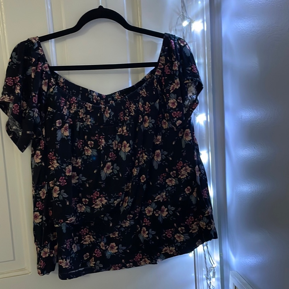 Black blouse with flowers.